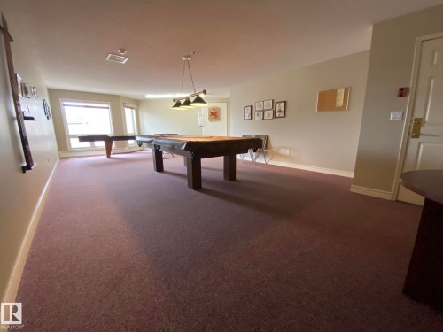 Spacious recreation room featuring recessed lighting and wall-to-wall carpeting - 102 10903 21 Avenue, Edmonton, AB - Indoor Photo Showing Other Room