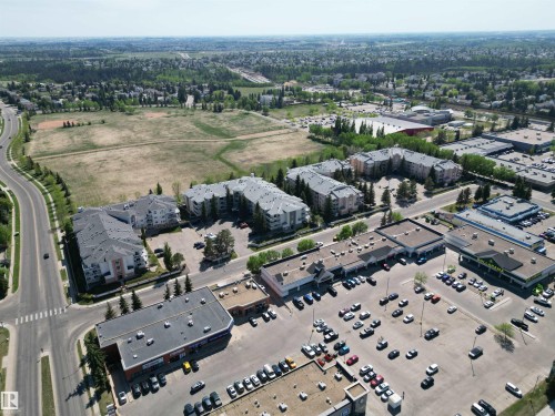 Aerial perspective showcasing multiple residential condominium buildings with dedicated parking areas - 102 10903 21 Avenue, Edmonton, AB - Outdoor With View