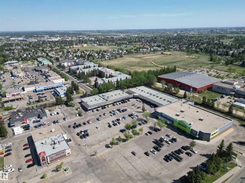 Aerial perspective showcasing commercial properties with expansive parking areas - 102 10903 21 Avenue, Edmonton, AB - Outdoor With View