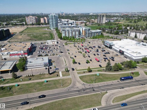 Aerial perspective showcasing a mixed-use commercial and residential district with multiple buildings - 102 10903 21 Avenue, Edmonton, AB - Outdoor With View