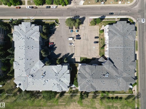 Aerial view showcasing two multi-unit residential buildings with gray shingle roofs - 102 10903 21 Avenue, Edmonton, AB - Outdoor With View