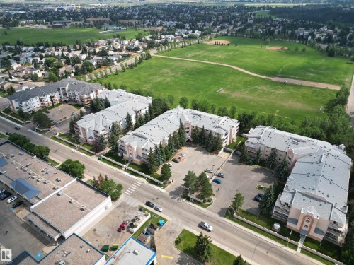 Aerial overview showcasing multiple multi-story residential buildings with pitched roofs and light-colored facades - 102 10903 21 Avenue, Edmonton, AB - Outdoor With View
