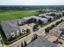 Expansive residential complex featuring multiple buildings with gabled roofs and private balconies - 