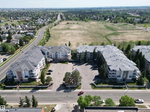 Two multi-story apartment buildings with light-colored facades and gray shingle roofs - 102 10903 21 Avenue, Edmonton, AB - Outdoor With View