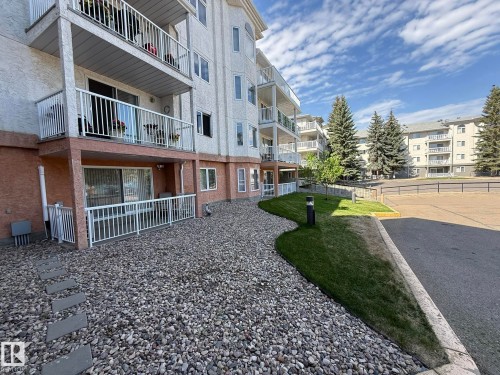 Multi-story building featuring white stucco siding and private balconies with white railings - 102 10903 21 Avenue, Edmonton, AB - Outdoor