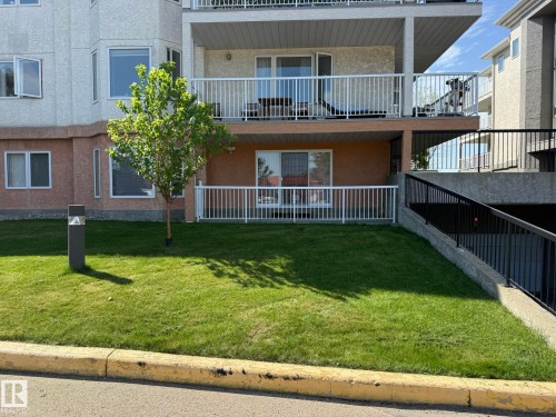 CLOSEUP PHOTO OF YOUR UNIT #102 WITH A NEW PATIO RAILING WITH A GATE TO THE LEFT! - 102 10903 21 Avenue, Edmonton, AB - Outdoor