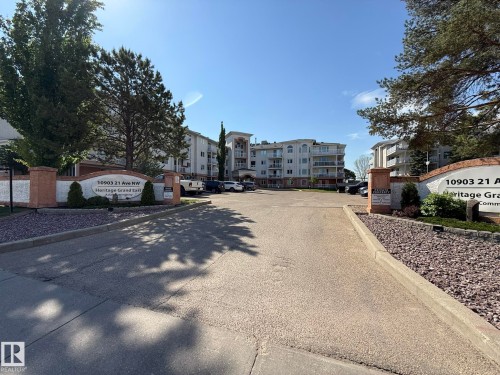 Entry drive to a multi-story residential building with a curved façade - 102 10903 21 Avenue, Edmonton, AB - Outdoor