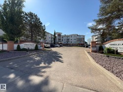 Entry drive to a multi-story residential building with a curved façade - 