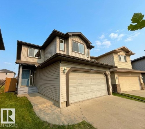 Two-story home featuring siding exterior, an attached two-car garage, and a concrete driveway - 1919 Hammond Place, Edmonton, AB 