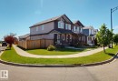 Residential street scene featuring row houses with gabled roofs, front porches, and light-colored siding - 17359 49 Street, Edmonton, AB 