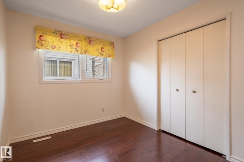 Dark wood-finish flooring complements the neutral wall tones - 11415 142 Avenue, Edmonton, AB 