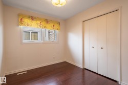 Dark wood-finish flooring complements the neutral wall tones - 