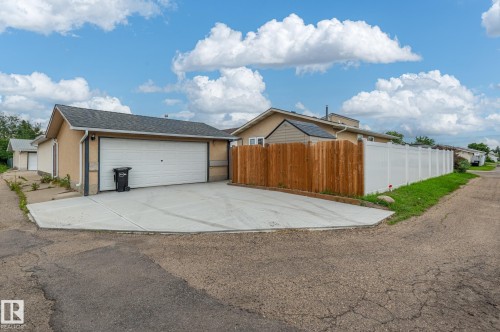Detached garage with a single overhead door and a concrete driveway - 11415 142 Avenue, Edmonton, AB 