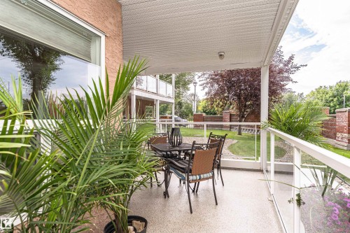 Covered balcony featuring a textured concrete floor and a white perforated ceiling - 130 9008 99 Avenue Nw, Edmonton, AB 