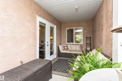 Covered patio with textured exterior walls and a white paneled ceiling - 130 9008 99 Avenue Nw, Edmonton, AB 