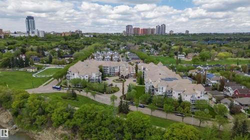 Residential complex featuring multiple buildings with private balconies and a central circular drive - 130 9008 99 Avenue Nw, Edmonton, AB 