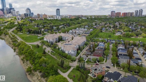 Riverfront residential community featuring multi-story buildings, established tree cover, and a park-like setting - 130 9008 99 Avenue Nw, Edmonton, AB 