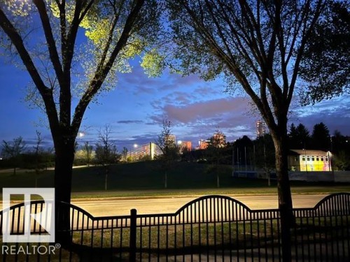 Black wrought iron fence with decorative top rail - 130 9008 99 Avenue Nw, Edmonton, AB 