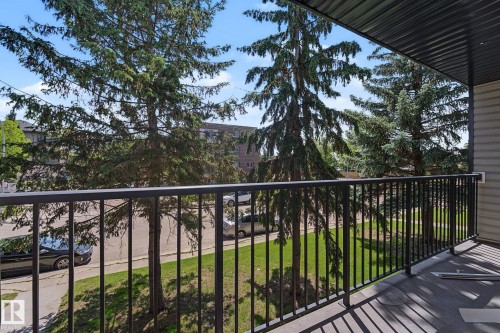 Private balcony featuring a black metal railing and a vinyl plank floor - #6E 11608 28 Av Nw Nw, Edmonton, AB - Outdoor With Balcony
