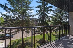 Private balcony featuring a black metal railing and a vinyl plank floor - 