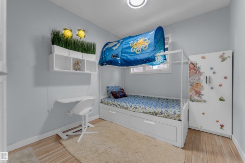 Light blue-painted room with wood-finish flooring - 1316 35 Street, Edmonton, AB 