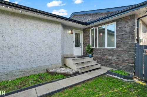 Exterior featuring stucco siding and stone veneer accents - 1316 35 Street, Edmonton, AB 