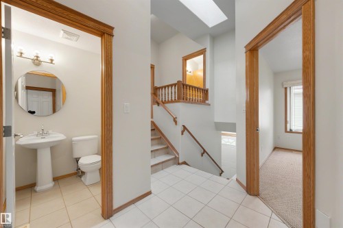Central entryway featuring white tile flooring and wood-finish trim - 15227 47 Street, Edmonton, AB 