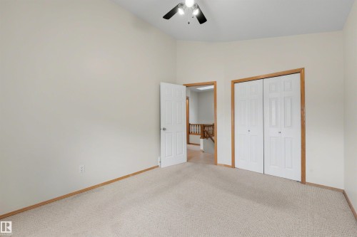 Neutral-toned walls complement the light-colored carpet flooring - 15227 47 Street, Edmonton, AB 