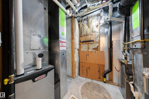 Dedicated utility space featuring a Lennox furnace and water heater - 15227 47 Street, Edmonton, AB 