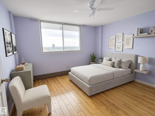 Spacious bedroom featuring wide plank wood-finish flooring, a large sliding window, a ceiling fan, and light purple wall tones - 1105 11007 83 Avenue, Edmonton, AB 