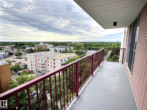 Private balcony with painted concrete flooring and red metal railings - 1105 11007 83 Avenue, Edmonton, AB 