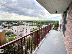 Private balcony with painted concrete flooring and red metal railings - 