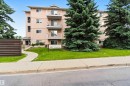 Multi-story residential building with light-colored exterior and multiple balconies - #304 4924 19 Av Nw, Edmonton, AB 
