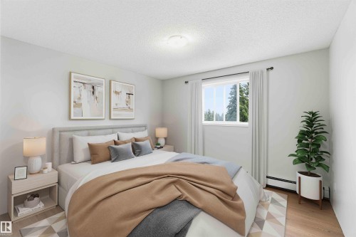 Bedroom featuring a large window, light wood-finish flooring, white walls, and a ceiling-mounted light fixture - #304 4924 19 Av Nw, Edmonton, AB 