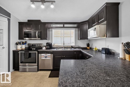 1073 Aspen Drive East, Leduc, AB - Indoor Photo Showing Kitchen With Double Sink