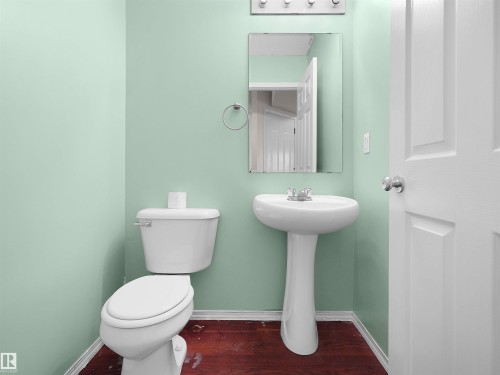 Pedestal sink with chrome fixtures and an overhead vanity light bar - 16106 131A Street, Edmonton, AB 