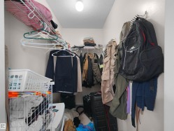 Walk-in closet with wire shelving system and overhead lighting - 