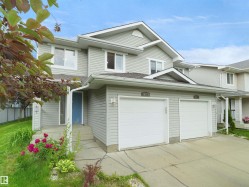 Two-story residence featuring light gray siding and white trim - 