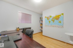 Hardwood flooring, built-in shelving, and a prominent window - 