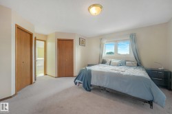 Recessed lighting, wood-finish bi-fold doors, and neutral carpeting - 