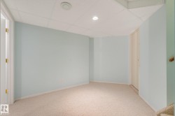 Carpeted flooring with light blue wall paint, drop ceiling, and recessed lighting - 