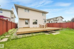 Expansive wooden deck with integrated steps, leading to a green lawn - 