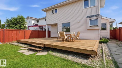 Expansive wooden deck with two-step entry to a grassy yard - 1225 Kane Wynd, Edmonton, AB 