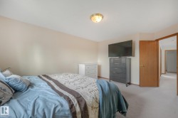 Wall-to-wall carpeting with light-toned walls and wood-trim doorways - 