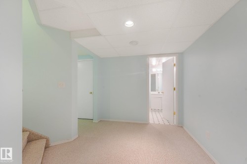 Light blue wall paint with recessed lighting, textured drop ceiling, and neutral carpet flooring - 1225 Kane Wynd Nw, Edmonton, AB - Indoor Photo Showing Other Room