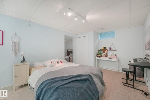 Wall-to-wall carpeting, recessed window, track lighting, and a built-in closet - 1225 Kane Wynd Nw, Edmonton, AB - Indoor Photo Showing Bedroom