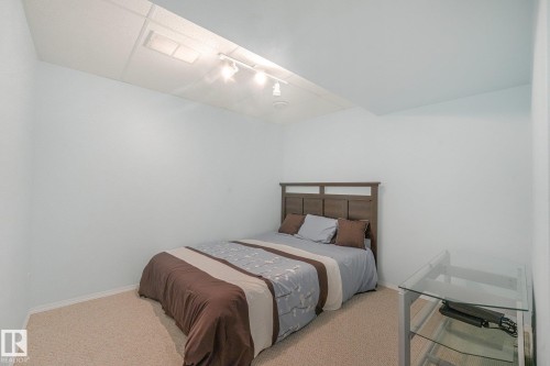 Recessed lighting, track lighting, neutral wall color, carpeted flooring, wood-finish headboard - 1225 Kane Wynd Nw, Edmonton, AB - Indoor Photo Showing Bedroom