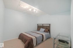 Recessed lighting, track lighting, neutral wall color, carpeted flooring, wood-finish headboard - 
