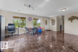 Spacious room featuring polished marble-effect floor tiles and neutral wall tones - 