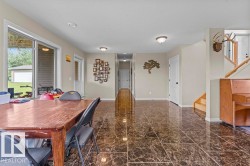 Spacious room featuring glossy, dark-toned tile flooring throughout - 